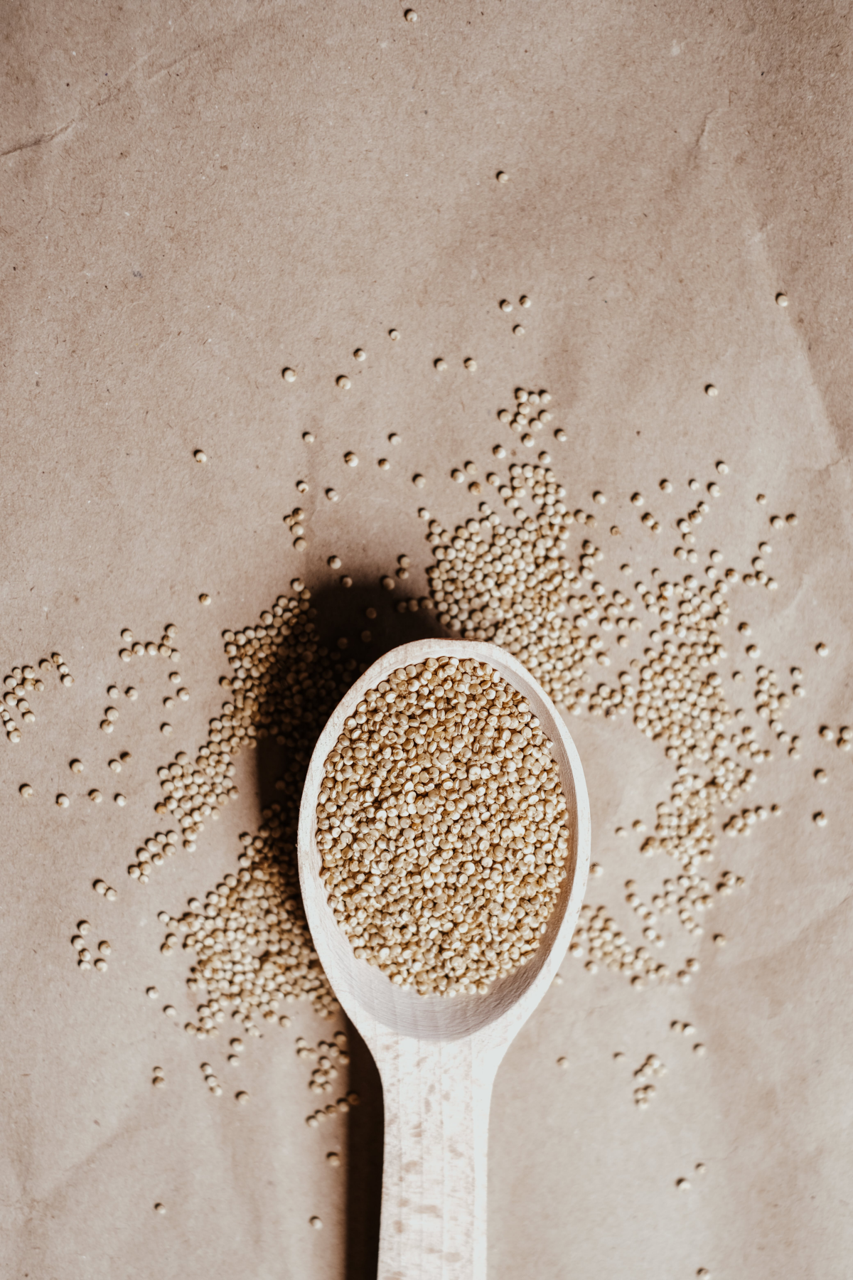 quinoa seeds in wooden spoon