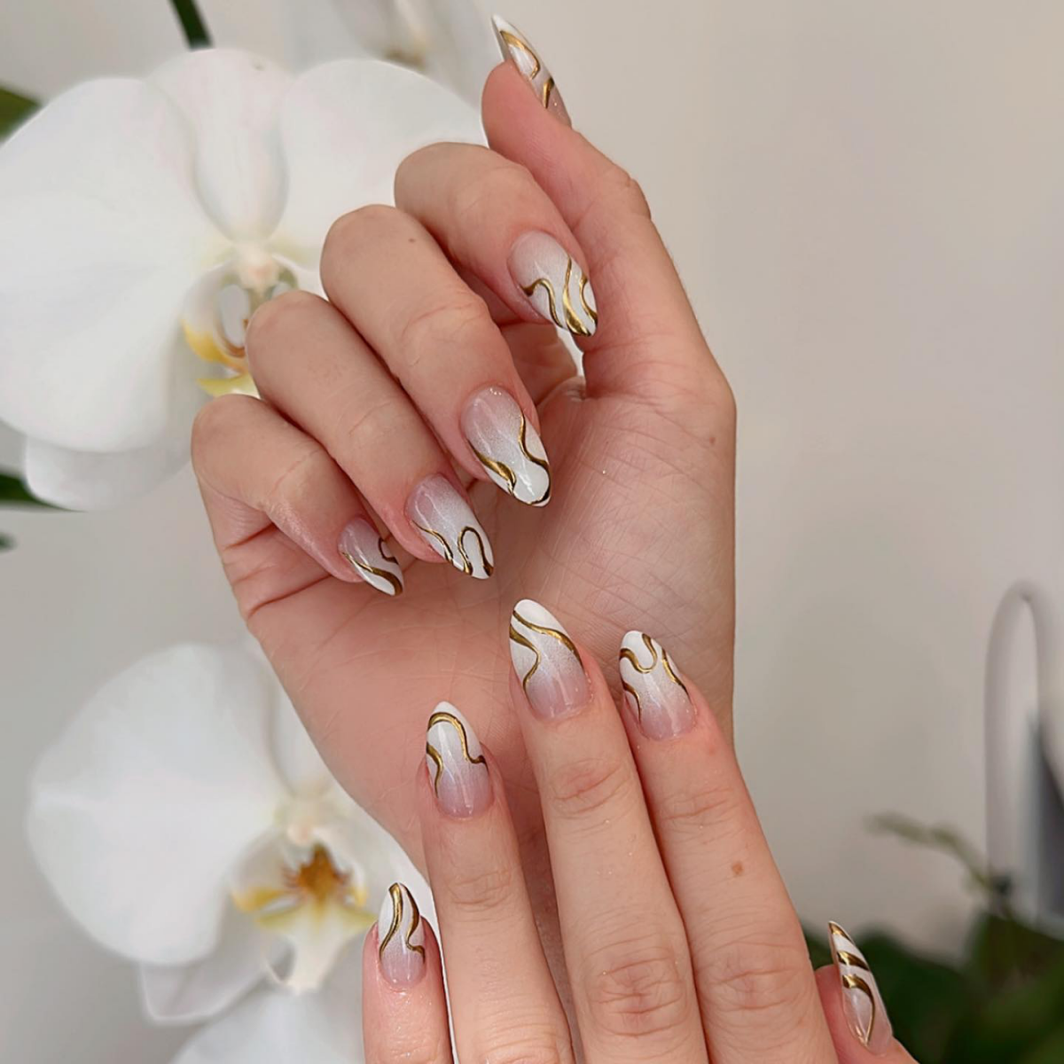 white ombre nails with gold accents