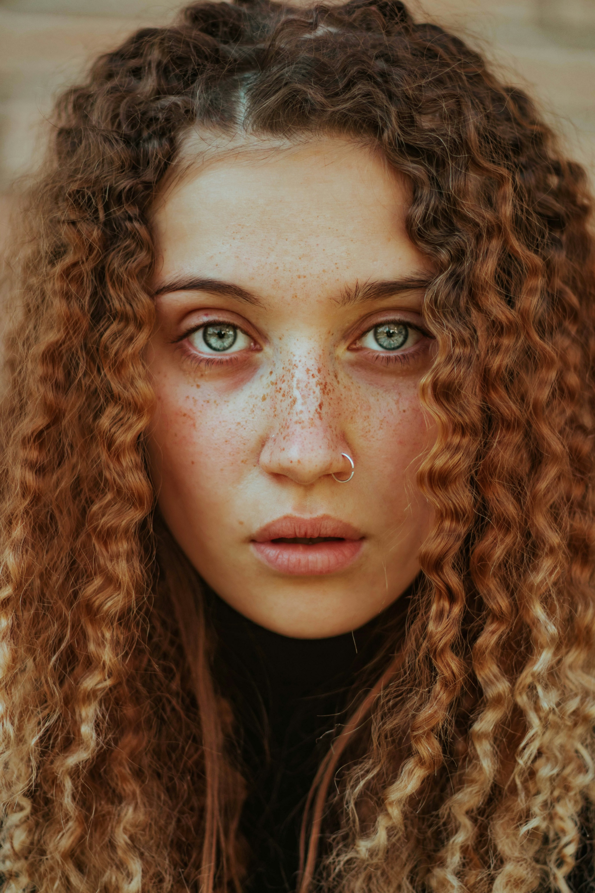 curly hair woman with freckles