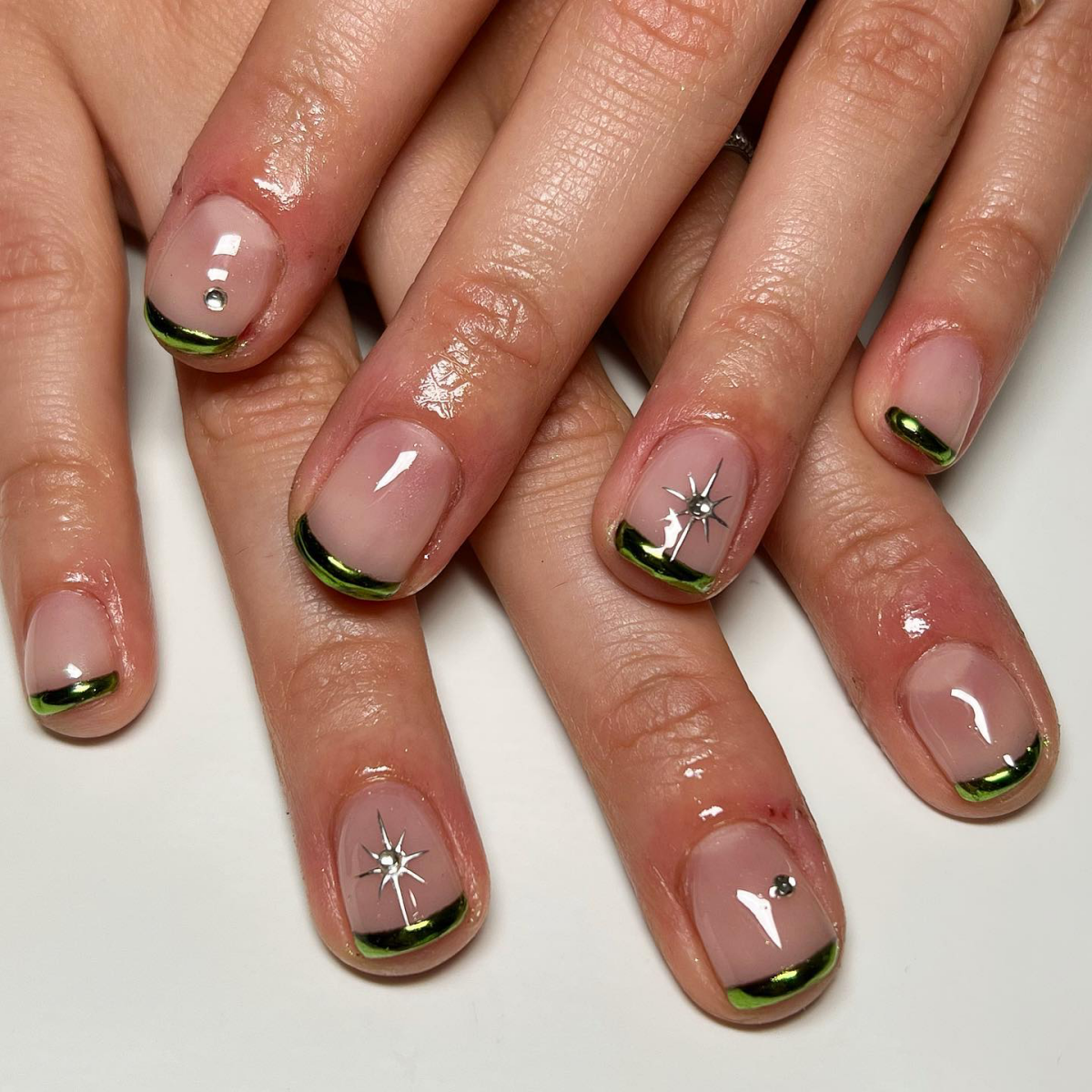 green french tips with chrome finish and silver stars