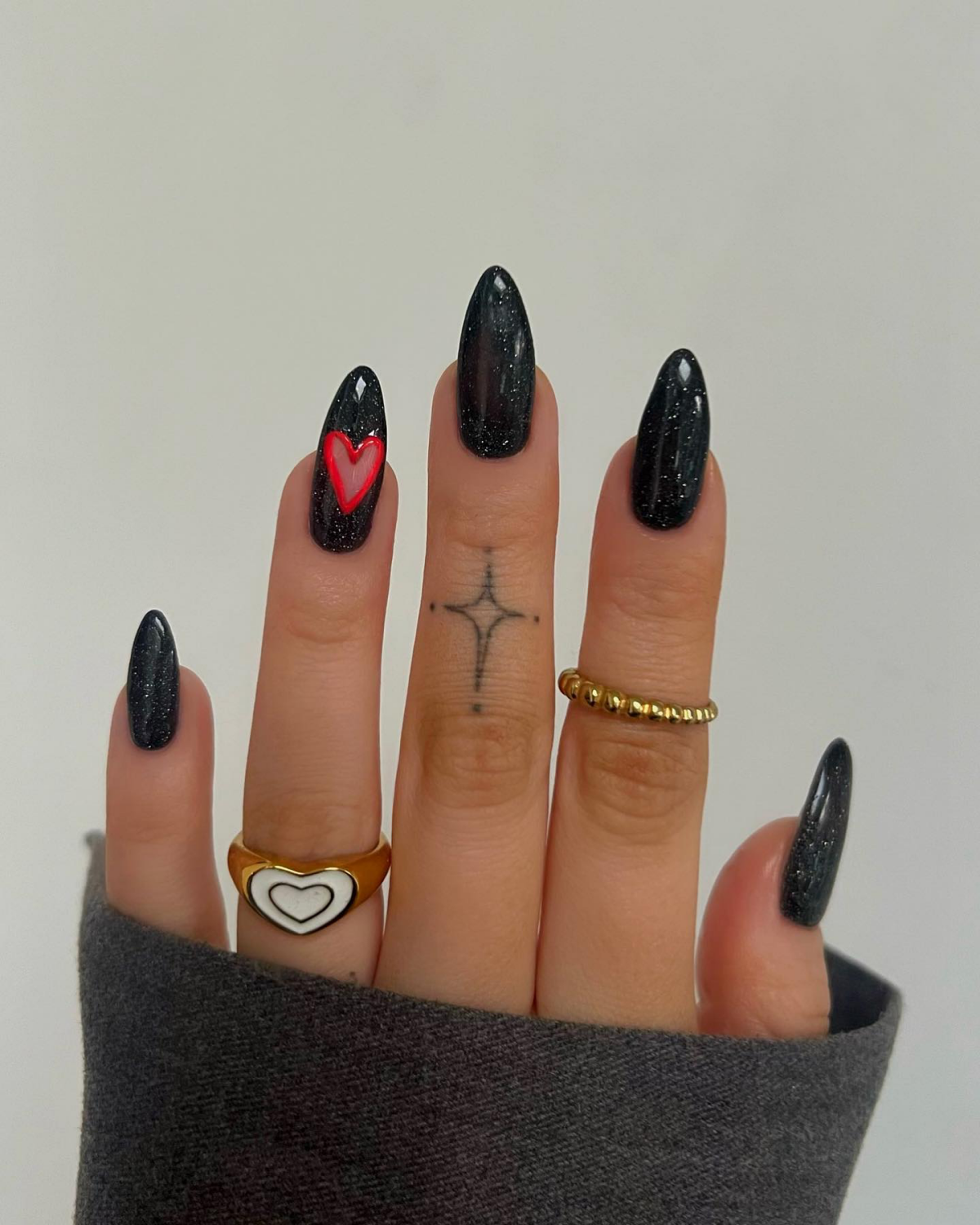 red heart on black glittery nails