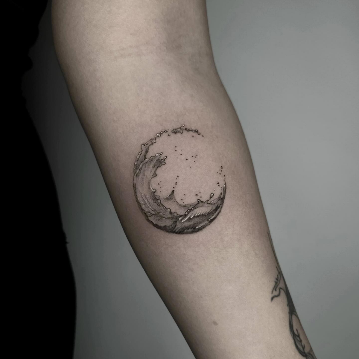 wave tattoo in circular form
