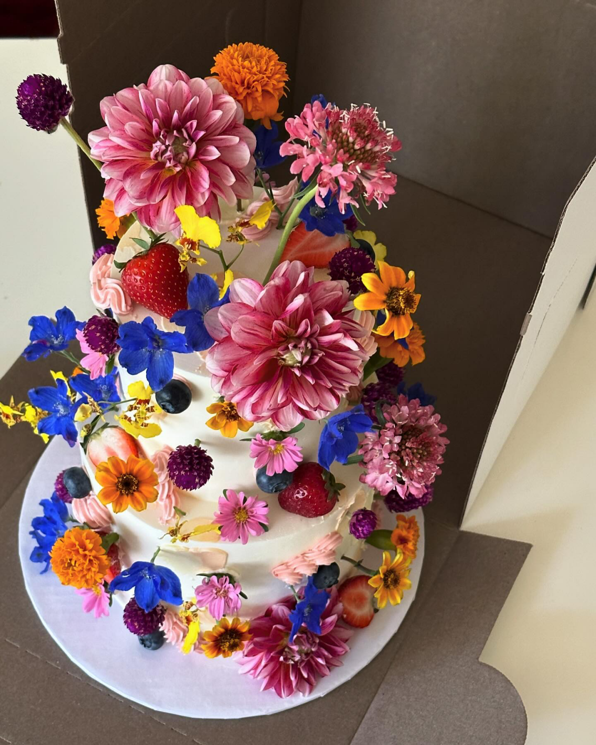white cake with colorful flowers