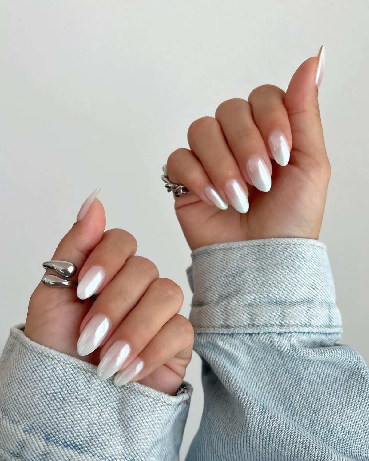 white chrome nails on two hands