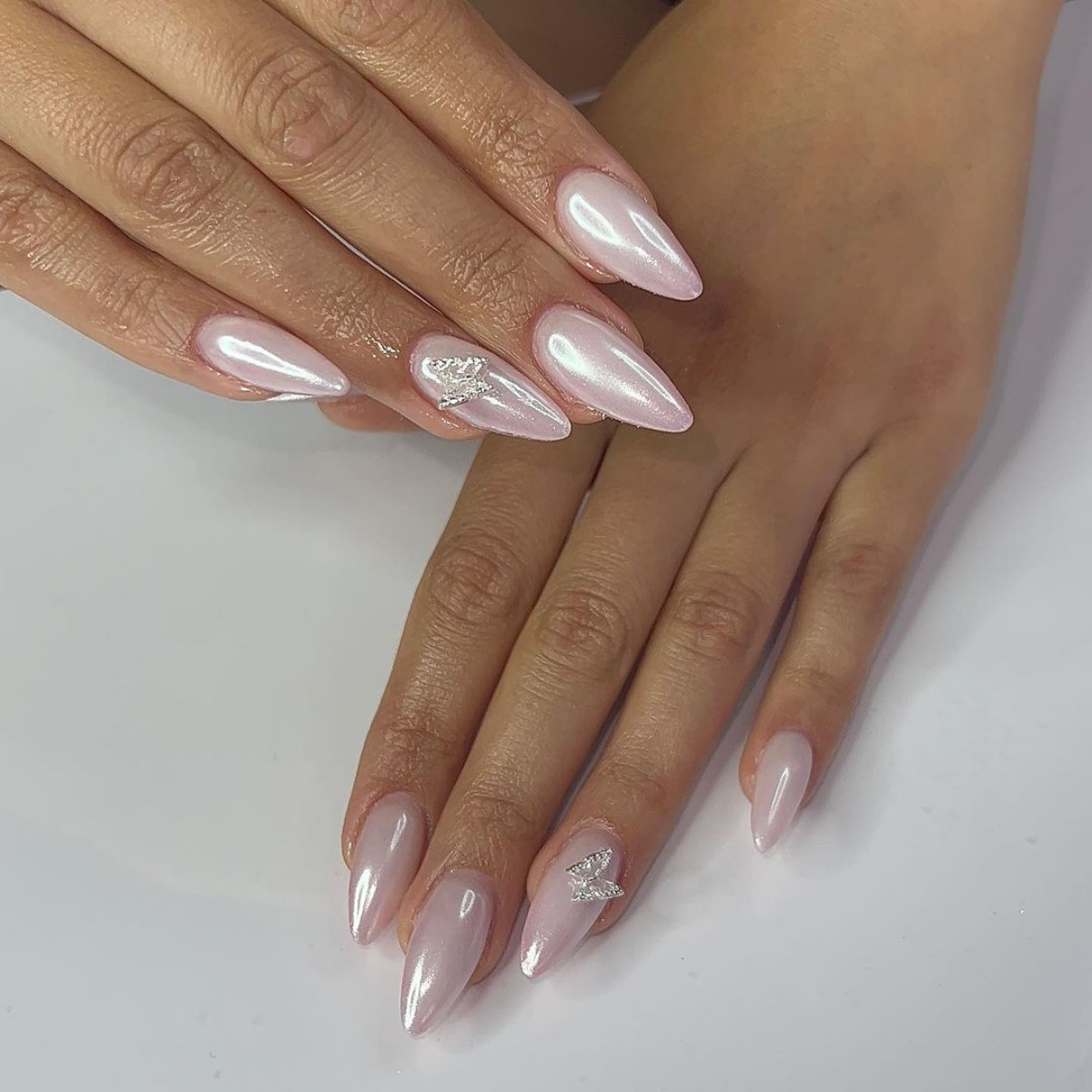 white chrome nails white nails with butterfly accent