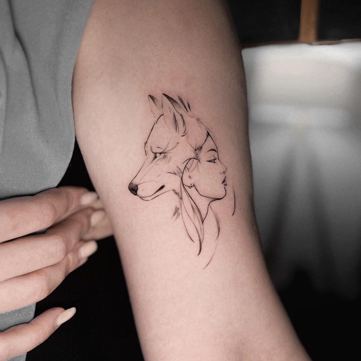 wolf and girl linework tattoo