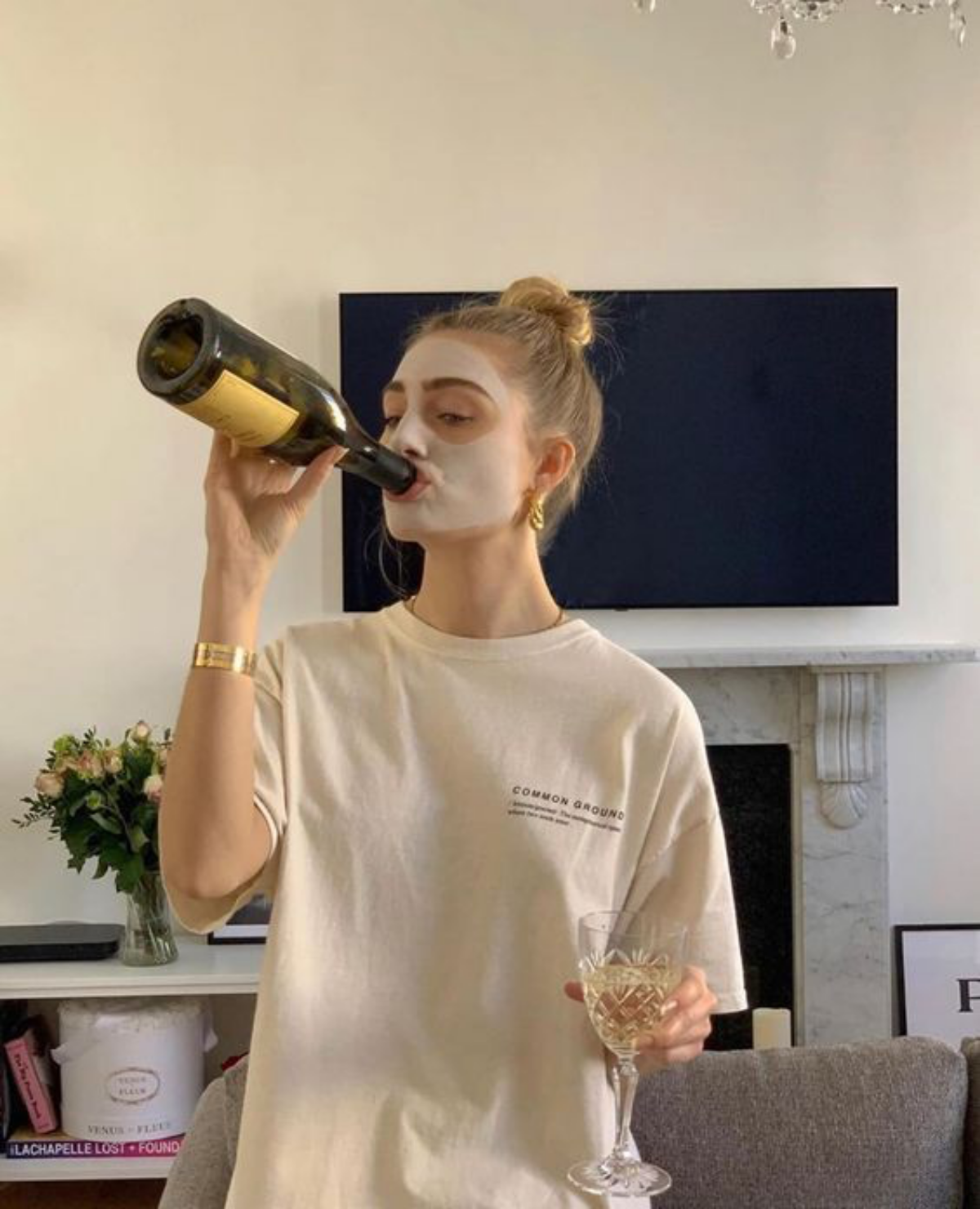 woman drinking wine with a mask on