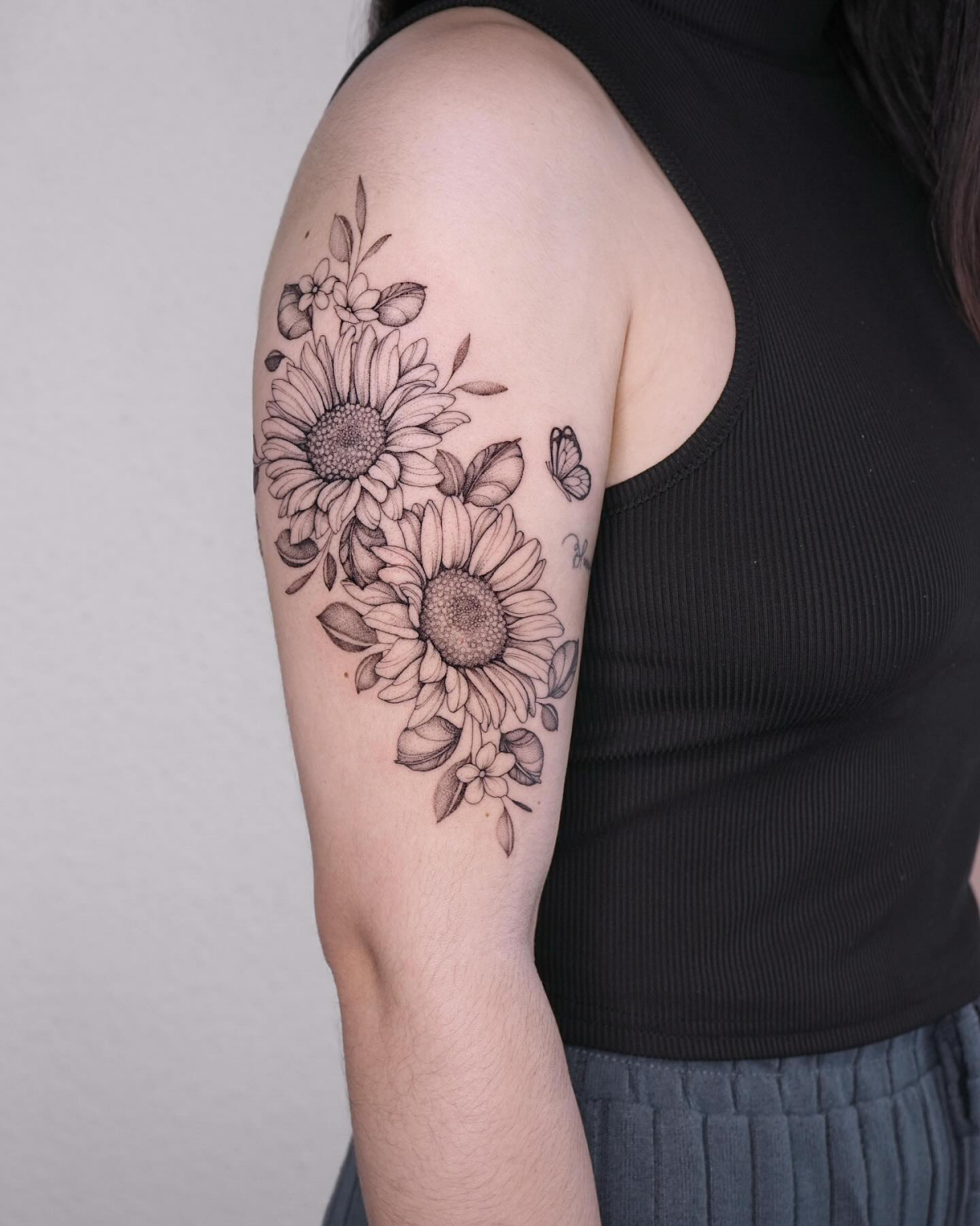 black and white tattoo of butterflies and sunflowers