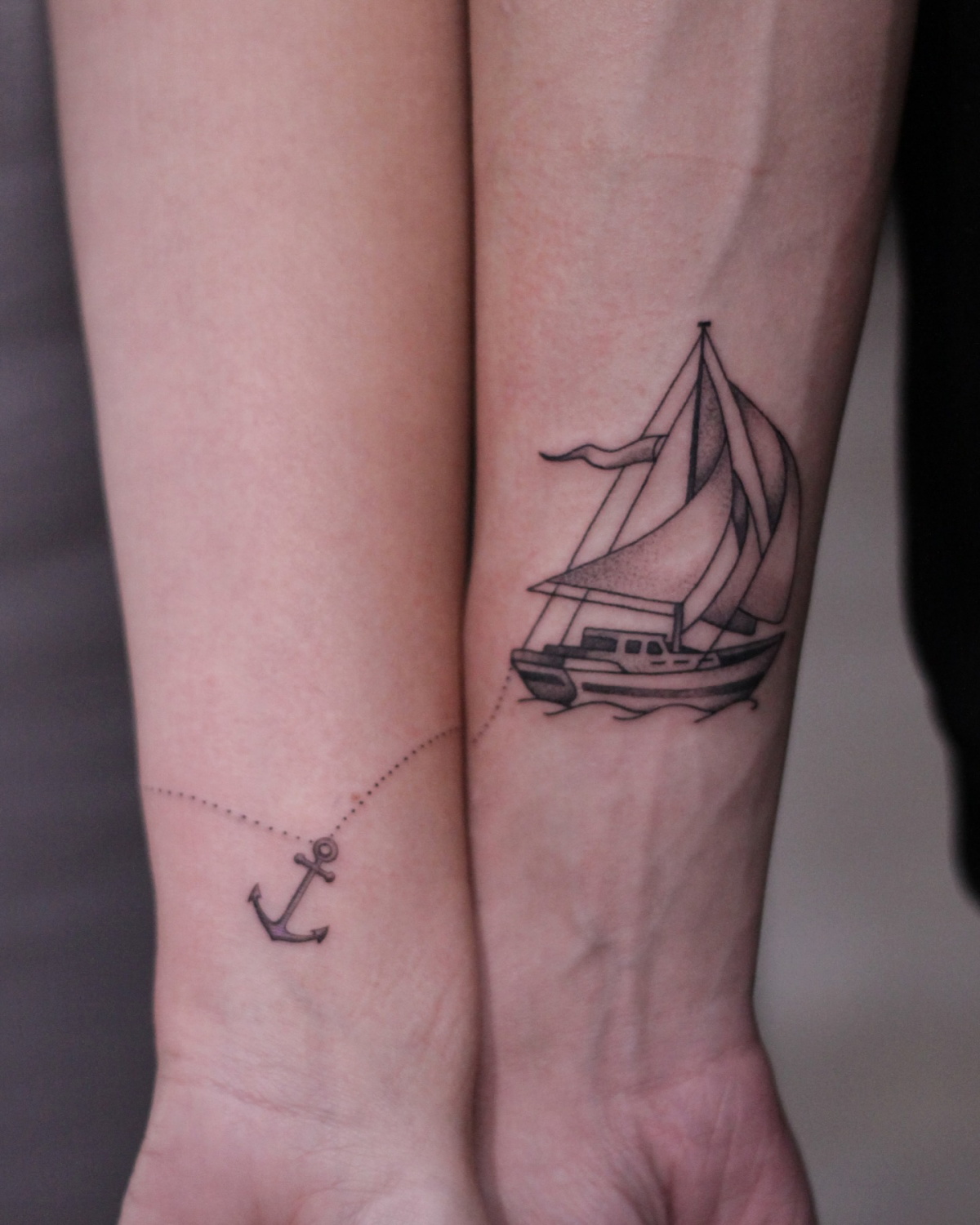 matching tattoo of ship and anchor