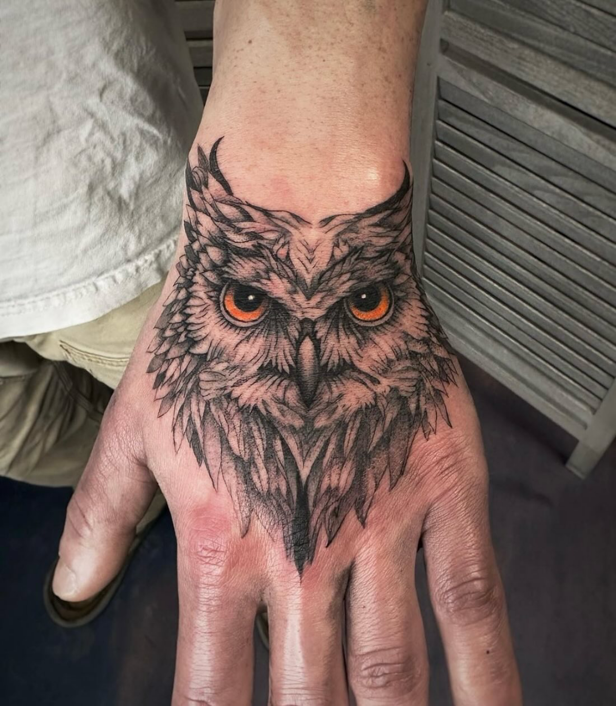 microrealism hand tattoo of an owl