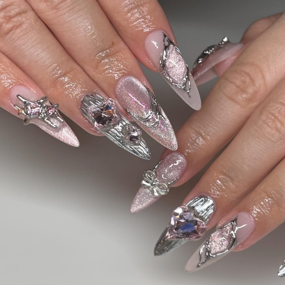pink fituristic nails with silver chrome accents