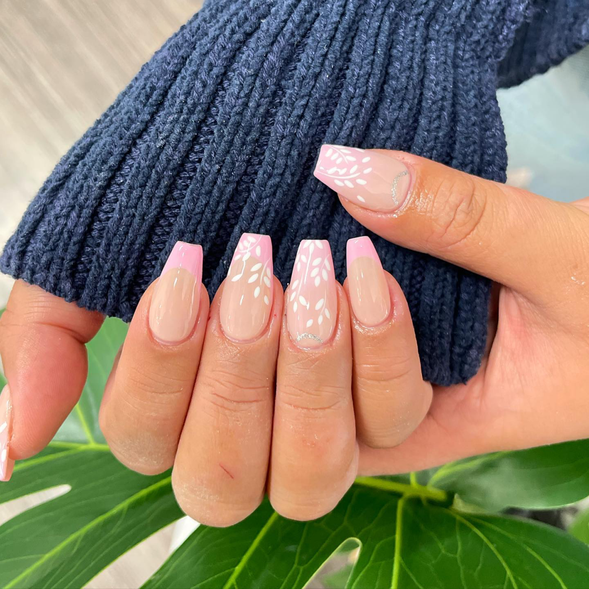 pink french tip on coffin nail with white flowers