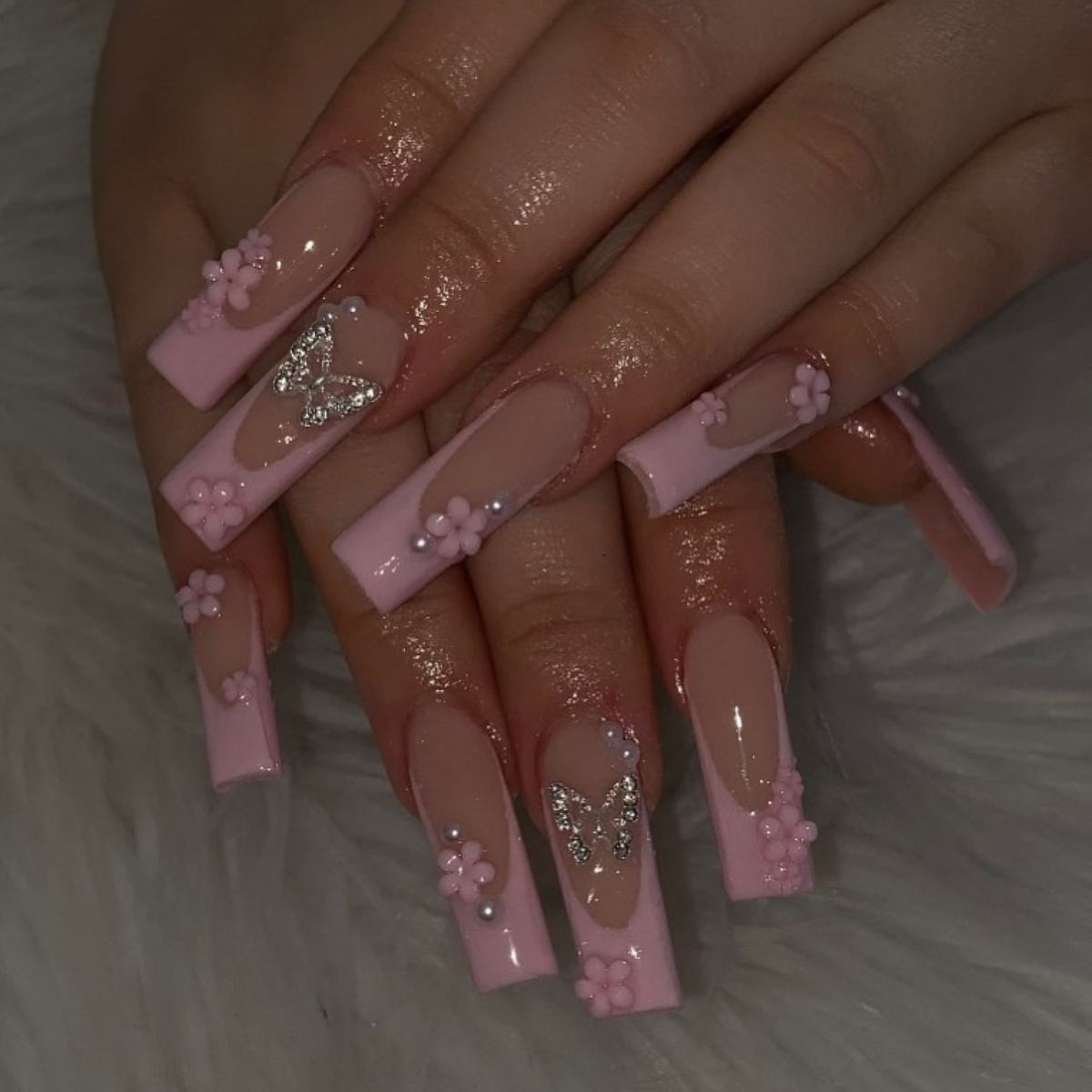 pink french tips with flowers and butterflies