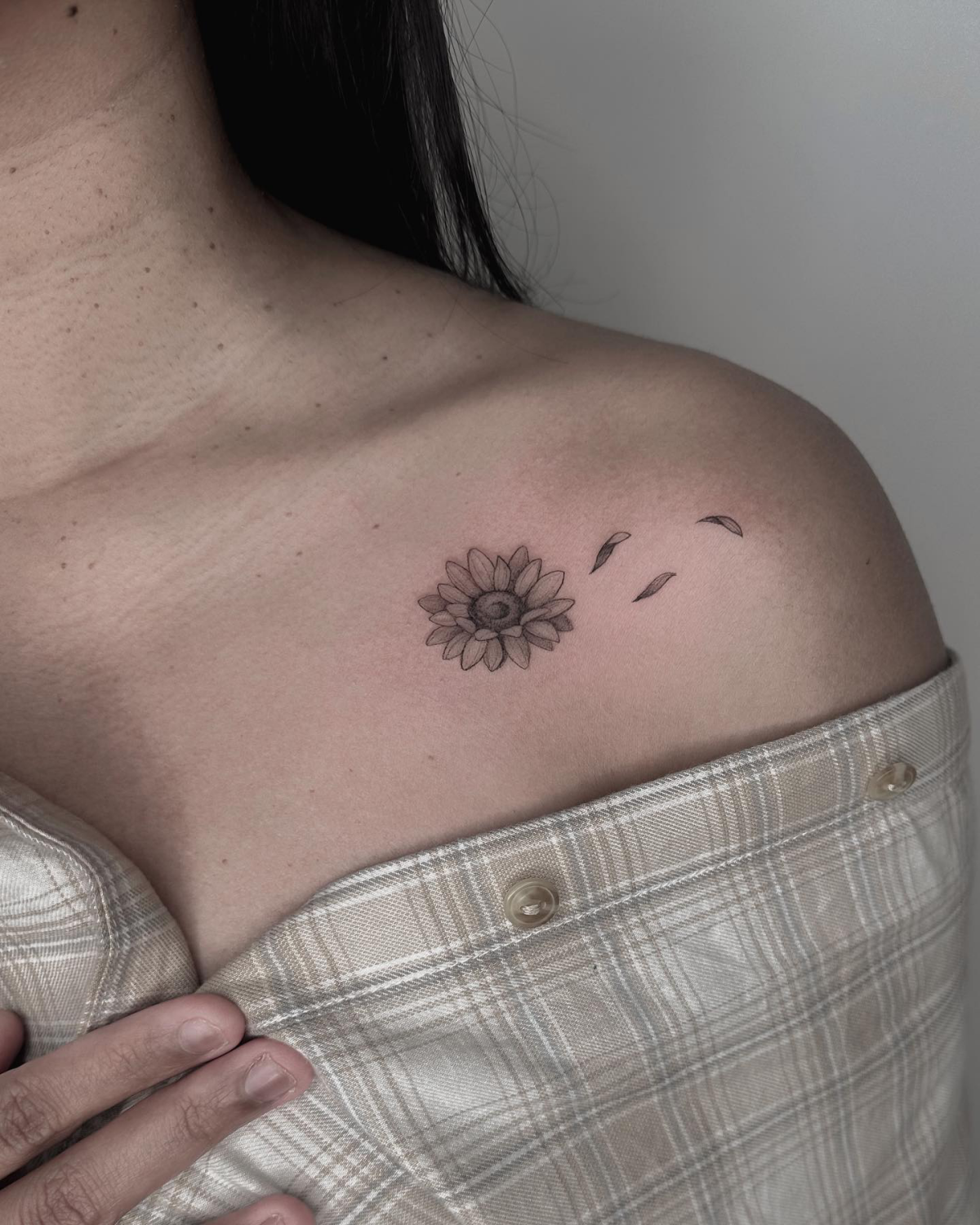 tiny sunflower collar bone tattoo