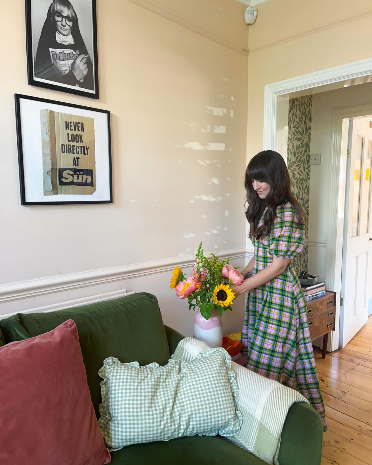 woman putting flowers in home
