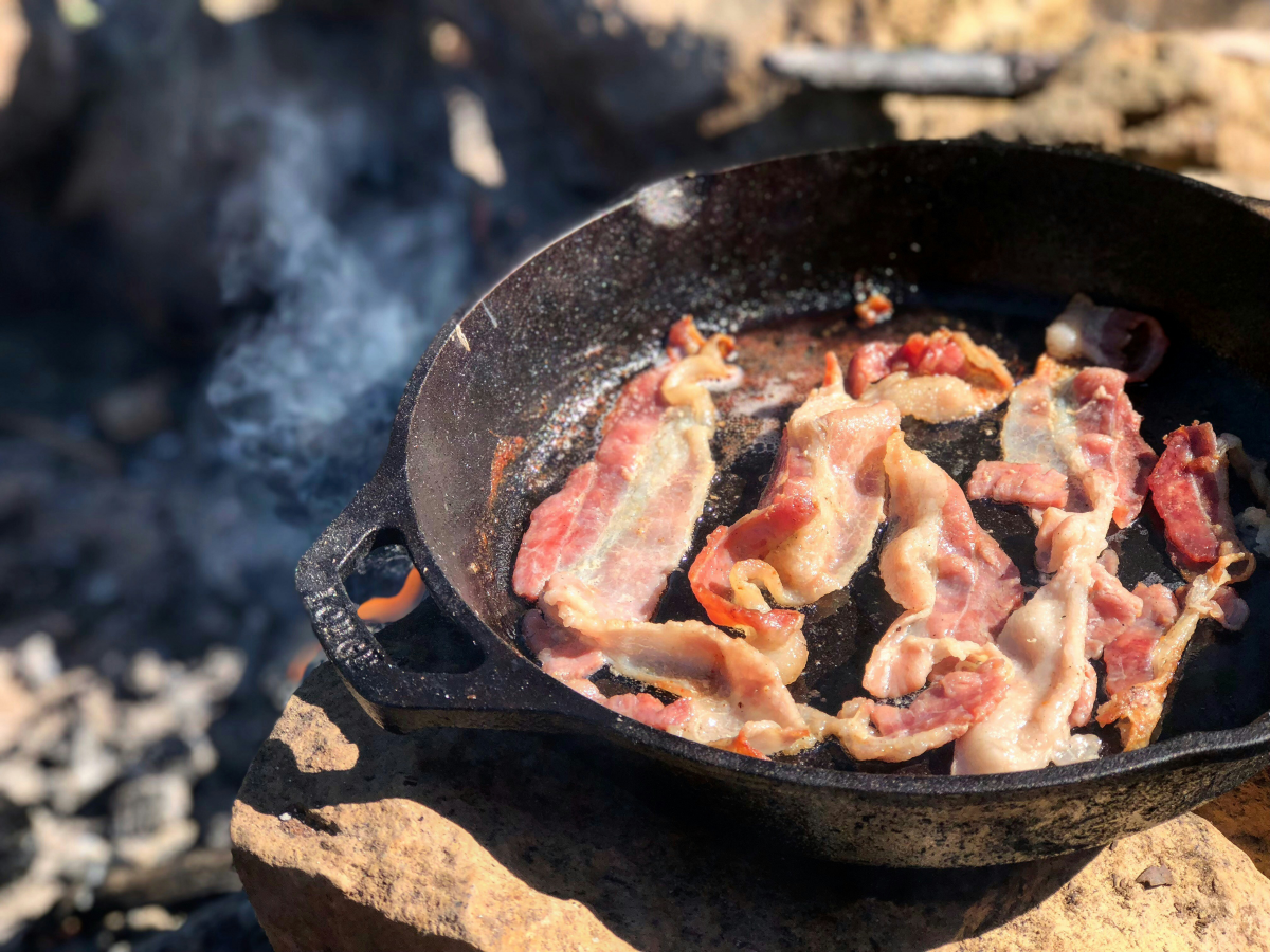 bacon sizzling on a pan