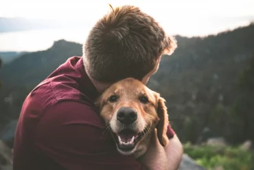 person hugging their dog