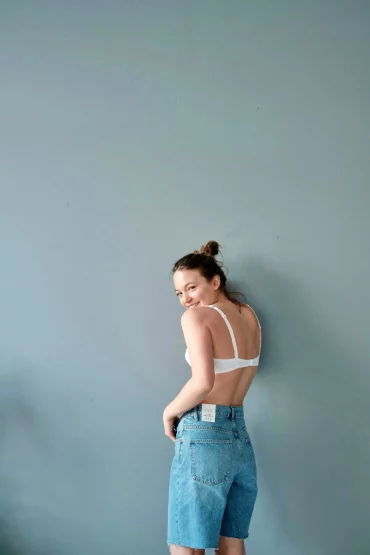 girl with a bra and short denim jeans